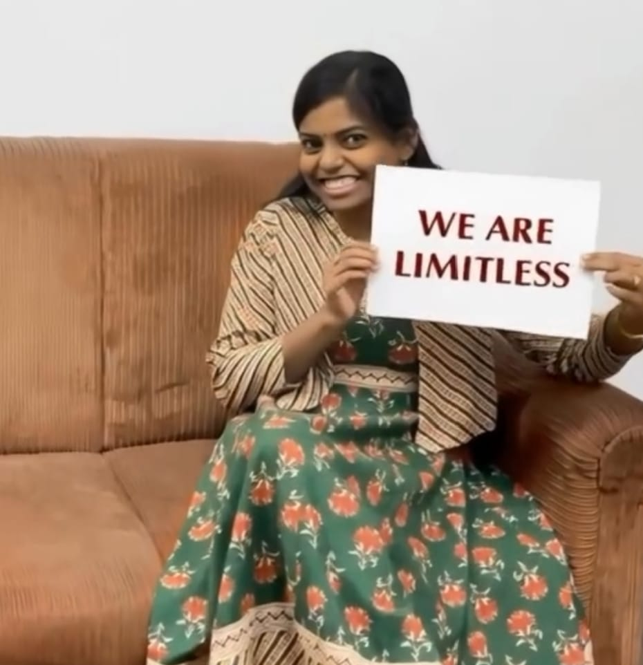 Sivamathi holding a 'We Are Limitless' sign