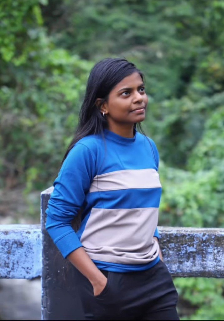 Sivamathi by a railing surrounded by greenery